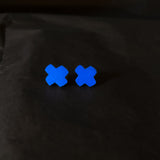 Two blue 'X' stud earrings on a black background