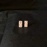 Rectangular earrings with a Terracotta brown and white pattern on a black background